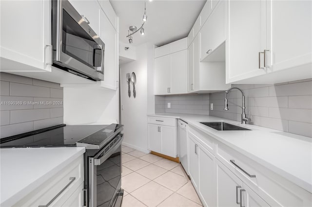 kitchen with sink, white cabinetry, and stainless steel appliances