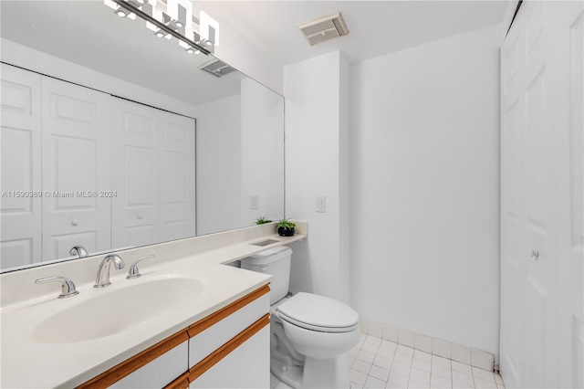 bathroom with vanity, toilet, and tile patterned floors