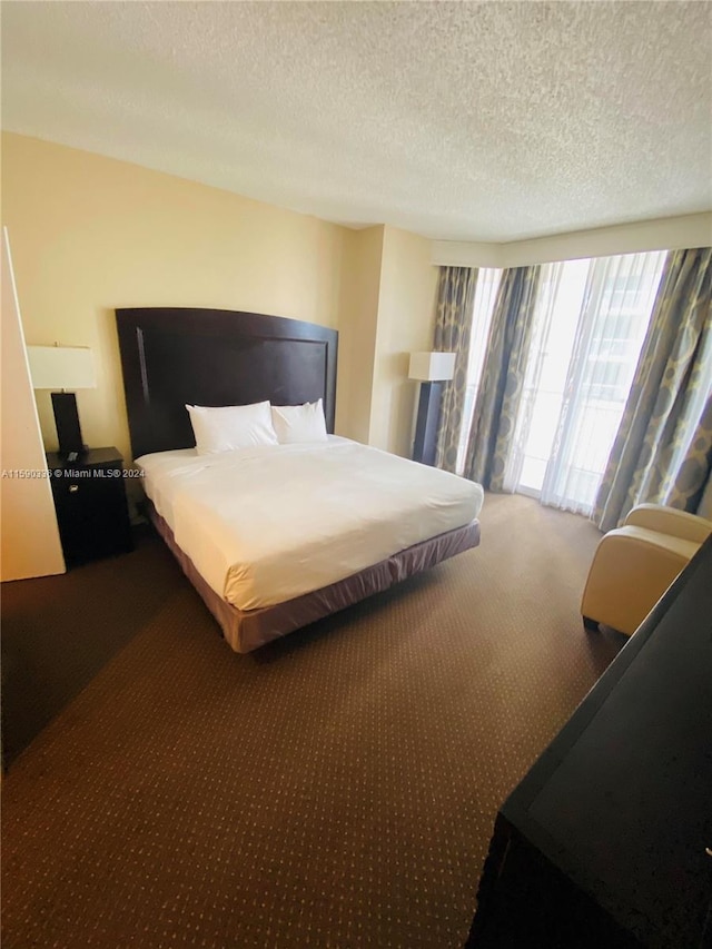 carpeted bedroom with a textured ceiling