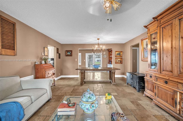 living room featuring light tile patterned flooring and a textured ceiling