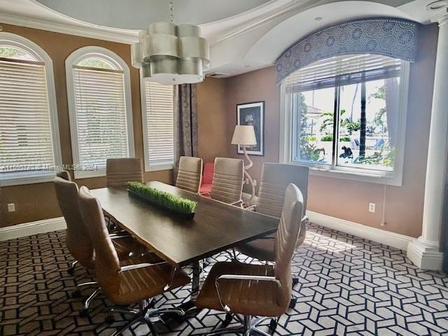 dining area featuring a healthy amount of sunlight, a notable chandelier, and ornamental molding