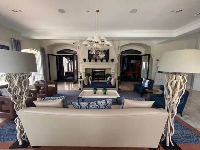 living room featuring a chandelier, tile floors, and crown molding