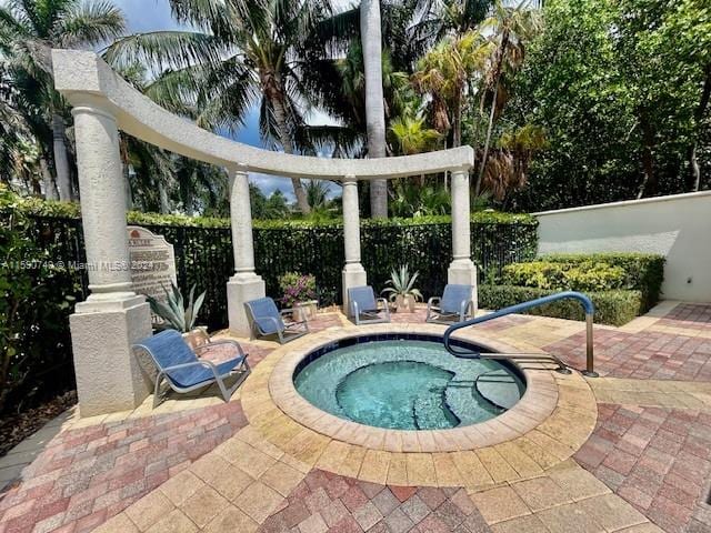 view of pool with a patio and an in ground hot tub