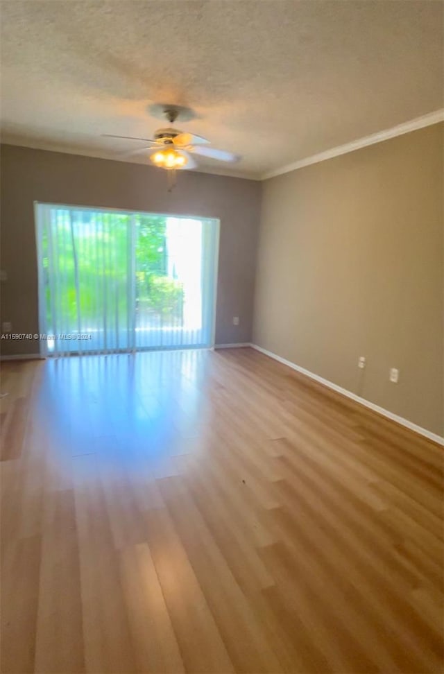 empty room with a textured ceiling, ceiling fan, and hardwood / wood-style floors