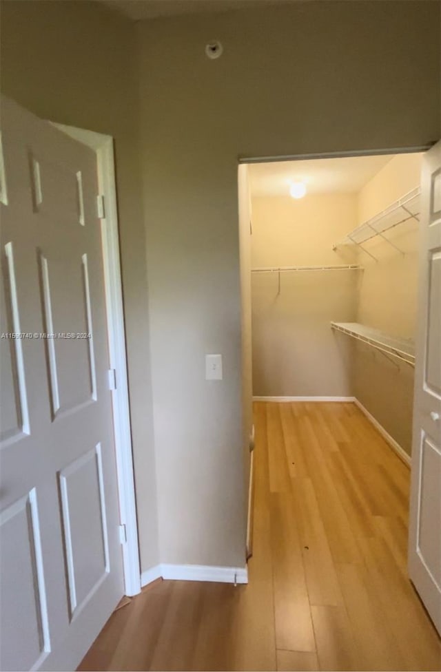 spacious closet featuring hardwood / wood-style floors