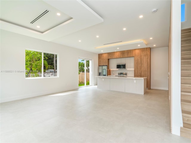 unfurnished living room featuring sink