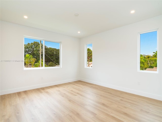 spare room with light hardwood / wood-style flooring