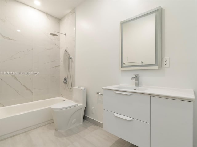 full bathroom featuring tiled shower / bath combo, vanity, and toilet