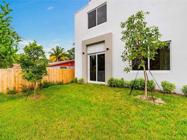 rear view of house featuring a lawn