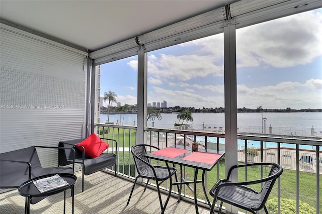 sunroom / solarium featuring a healthy amount of sunlight and a water view