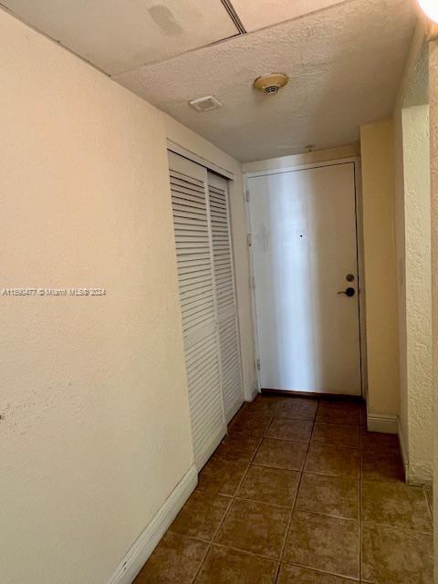 hallway featuring tile flooring