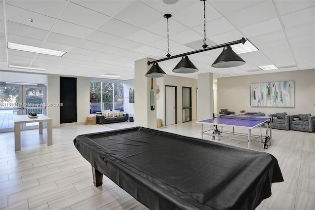 playroom with a paneled ceiling, pool table, and french doors