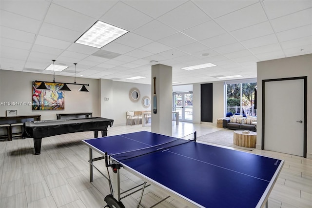 recreation room featuring a paneled ceiling, pool table, and light tile floors