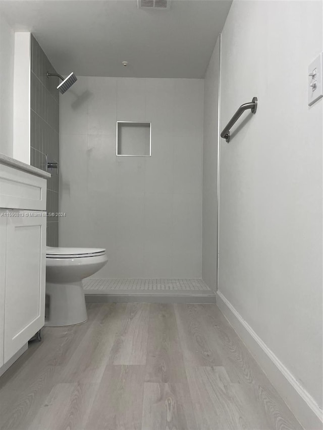 bathroom with hardwood / wood-style floors, toilet, and vanity