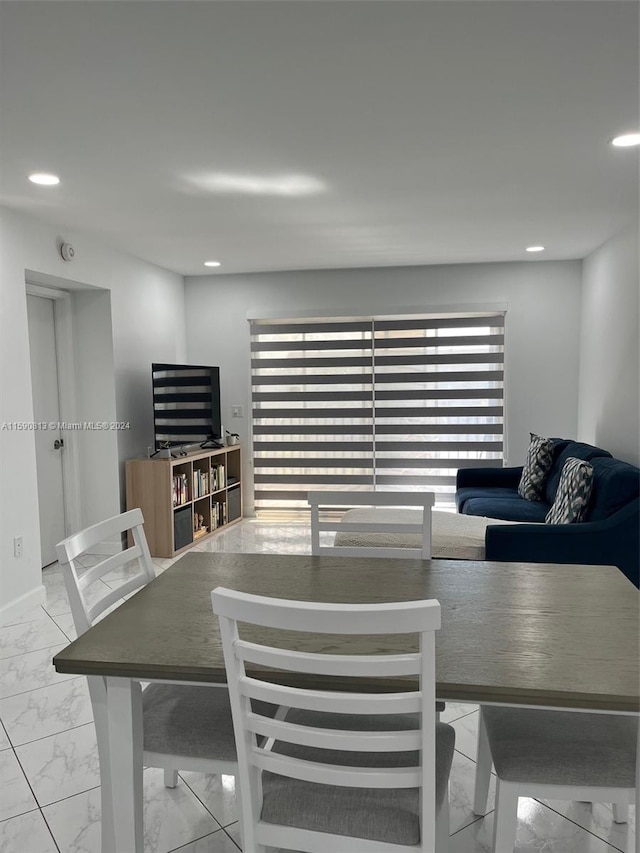 dining area featuring light tile floors