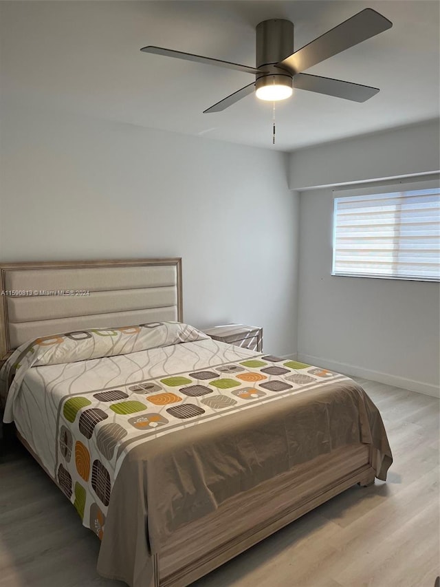 bedroom featuring wood-type flooring and ceiling fan