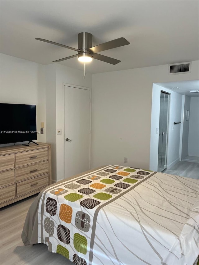 bedroom with ceiling fan and light hardwood / wood-style flooring