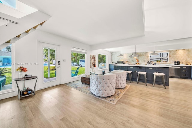 living room with a wealth of natural light and light wood-type flooring