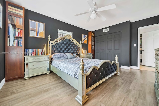 bedroom with a closet, ceiling fan, and light hardwood / wood-style flooring