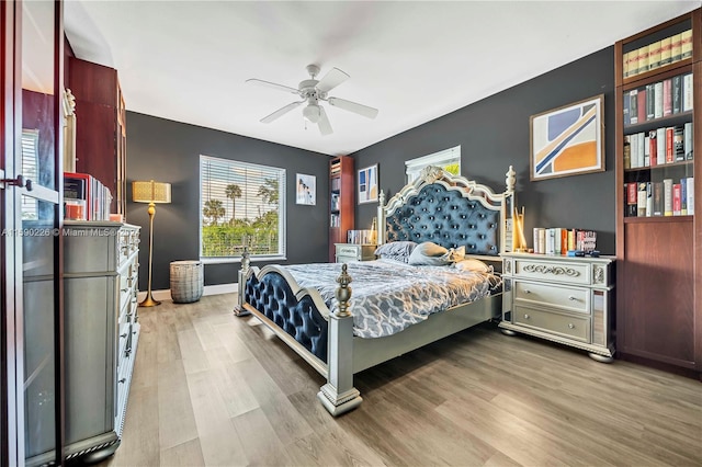 bedroom with ceiling fan and wood-type flooring