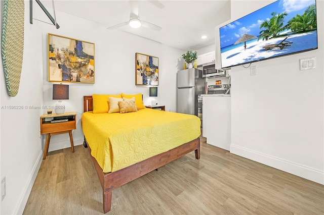 bedroom featuring stainless steel fridge, ceiling fan, and light wood-type flooring