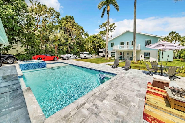 view of pool with a lawn and a patio