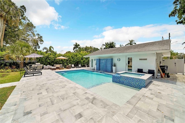 view of pool with a patio area and an in ground hot tub