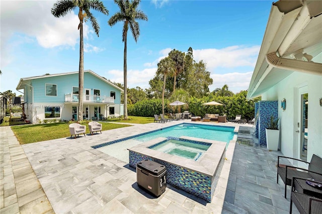 view of pool featuring a lawn, an in ground hot tub, and a patio area