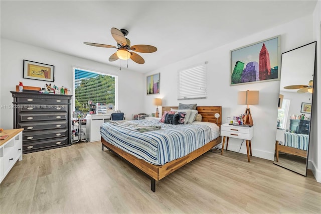 bedroom with light hardwood / wood-style floors and ceiling fan