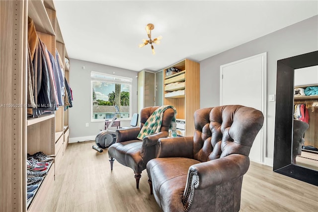 living room with a notable chandelier and light wood-type flooring