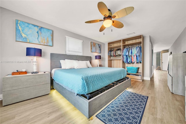 bedroom featuring ceiling fan, a closet, and hardwood / wood-style flooring