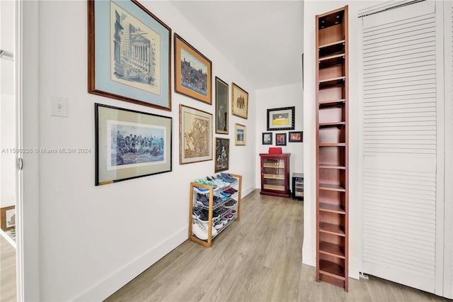 corridor with light wood-type flooring