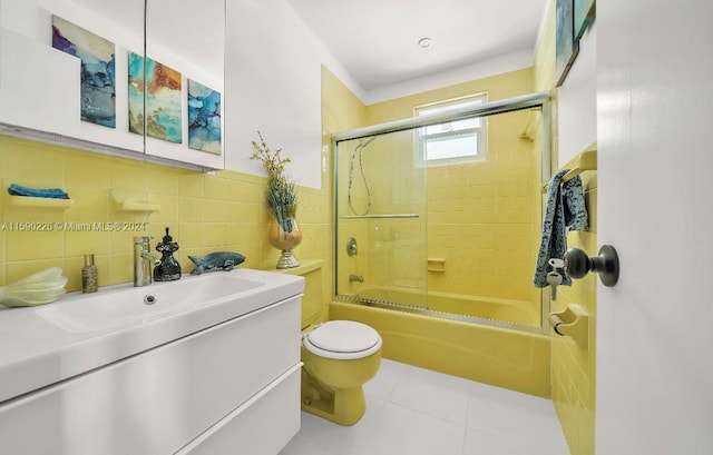 full bathroom with tile walls, backsplash, toilet, tile floors, and vanity