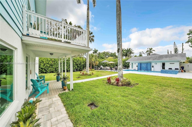 view of yard with a balcony and a patio area