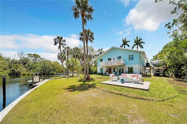 exterior space featuring outdoor lounge area, a patio, a water view, and a yard