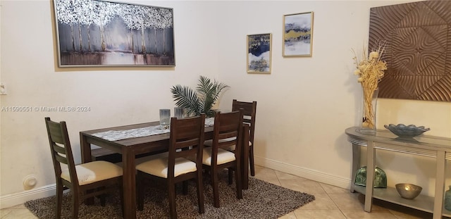 dining space featuring light tile patterned flooring