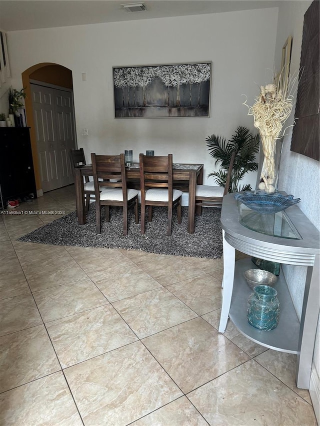 kitchen with white cabinets, white appliances, and tile patterned floors