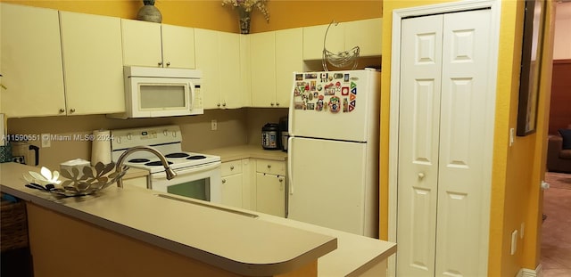 kitchen with white cabinets, white appliances, and tile patterned flooring