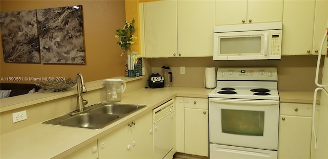 kitchen featuring white appliances and sink