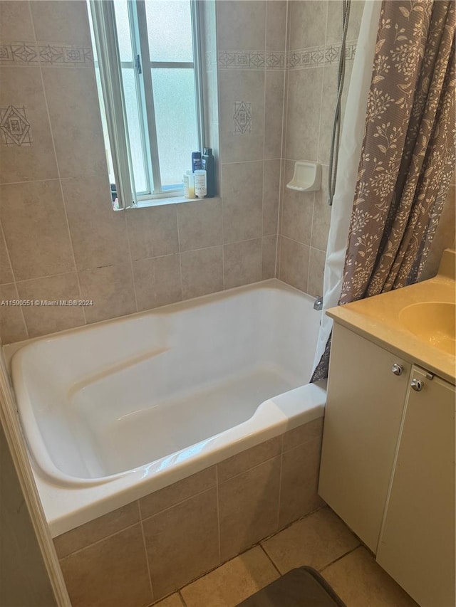 bathroom with shower / tub combo, vanity, and tile patterned flooring