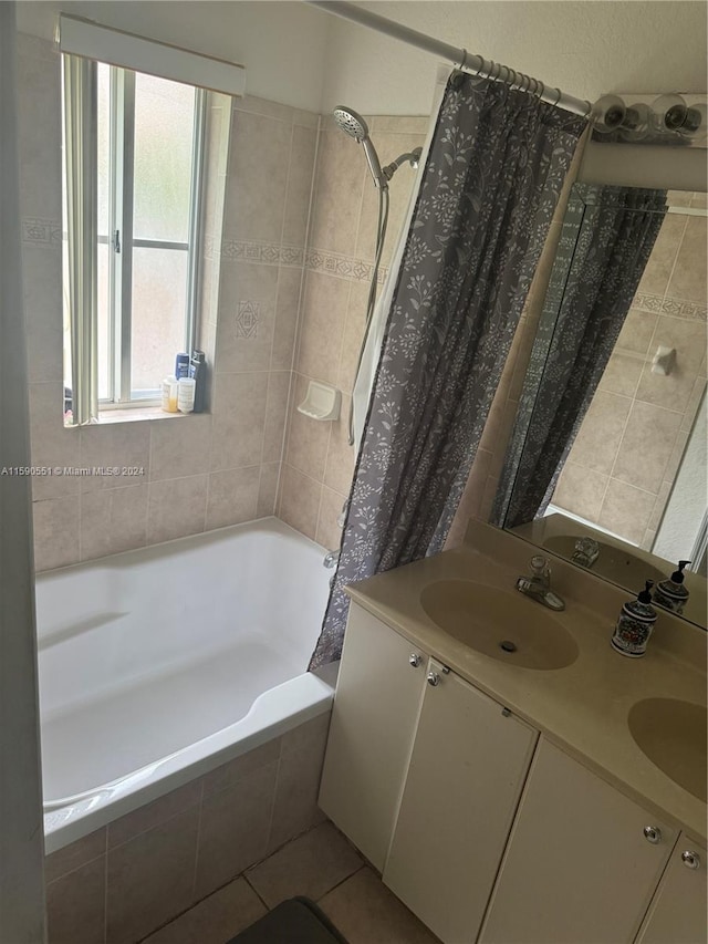 bathroom featuring shower / bath combination with curtain, tile patterned floors, and dual bowl vanity