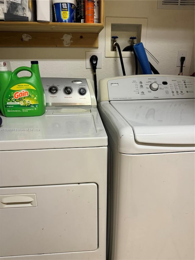 laundry room featuring washing machine and clothes dryer