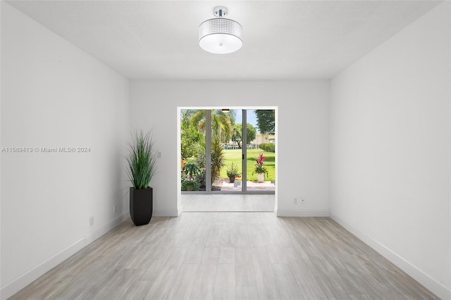 unfurnished room with light wood-type flooring