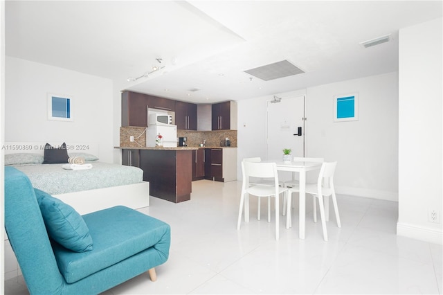 dining space featuring light tile floors