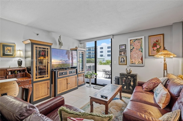 tiled living room featuring a textured ceiling