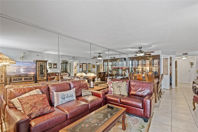 tiled living room featuring ceiling fan