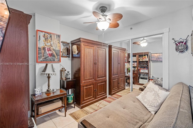 interior space featuring light tile flooring and ceiling fan