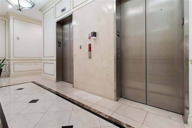 hallway featuring light tile floors and elevator