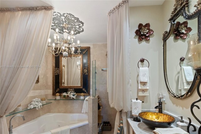 bathroom with a tub, a notable chandelier, and sink