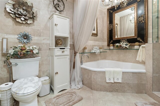 bathroom with tile walls, tile floors, tiled tub, and toilet